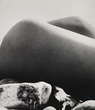 An untitled silver print by Bill Brandt of a knee and rocks