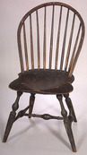 A bow-back Windsor side chair in black paint over earlier green, nine spindles, saddle seat, John Sprosen, Philadelphia or New York City, circa 1785 to 1795