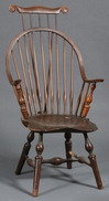 By John Sprosen, a Windsor comb-back armchair branded
