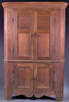 A corner cupboard with four paneled doors, walnut and poplar, southern Indiana, mid 19th century