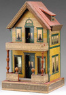 A lithographed paper-on-wood dollhouse by Whitney Reed, having a shingle and brick facade, with simulated gutters on each side