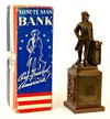 A Banthrico Minuteman white metal coin bank in original box with key