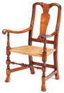 A Queen Anne eighteenth century maple armchair having a carved yoke crest and scrolled handgrips, rush seat and Spanish feet