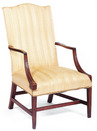 A Federal mahogan lolling chair having a canted back with serpentine crest, Massachustts circa 1800