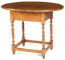 An oval topped New England Queen Anne maple tavern table having block and turned legs joined by a box stretcher on button feet