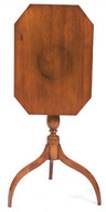 A Federal cherry and maple candlestand having an octagonal top supported by a turned pedestal on spider legs