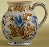 A Doulton Lambeth, salt-glaze cream jug, dated 1874, by Emily J. Edwards, brown and blue leaves