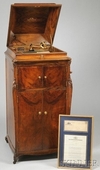 A Victor Victrola VV-XVI Phonograph in Circassian walnut cabinet with ogee lid and apron