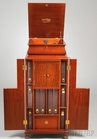 A Victor Victrola VTLA ogee form phonograph on mahogany upright cabinet with ten original albums and maker's booklet plus accessories