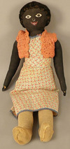 An oil cloth golliwogg doll with painted features