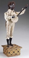 A Leopold Lambert musical automaton featuring a black banjo player with papier-mache head, inset brown glass eyes, and original black caracul wig