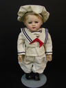 A Martha Chase boy child doll with oil-painted stockinette head and limbs, blue painted eyes and blonde hair, dressed in a newer three-piece sailor suit
