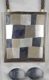 Modernist married metal pendant, Deborah Krupenia, dated 2002, the large rectangular plaque composed of various married metals, suspended from fabric cord, ear clips en suite, maker's mark