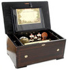 A rare Swiss orchestral cylinder music box, probably Edward Jaccard circa 1870, inlaid and marquetry hinged cover over conforming case, opening to reveal 9 1/4-inch 10-tune cylinder