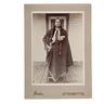 Irwin cabinet card photograph of Quanah Parker, the Comanche chief, standing on his porch