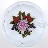 Trabucco magnum pedestal paperweight. Bouquet magnum paperweight, pink rose, 2 red flower blossoms & bud, six blueberries and two pink buds with green leaves and stems, bouquet rests on an upset muslin ground. Multi-side facets on a clear pedestal foot. Signed in script