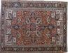 Gorevan Heriz carpet, northwest Persia, early 20th century, the indigo, cream and brick red angular lobed floral medallion anchored on a brick floral vine filled field flanked by cream spandrels, all within a deep indigo palmette and floral vine border
