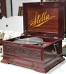 A Stella double comb disc music box in a mahogany case with carved foliate decoration and single drawer, plus near 50 discs