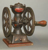 A Landers, Frary and Clark cast iron countertop coffee mill with drawer and two wheels