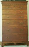 A six-drawer Chippendale tall chest on bracket feet, the frieze with carved stylized leaves, birch with red stain, Dunlap School, New Hampshire, 1780 to 1810