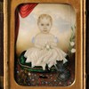 A 19th century watercolor on ivory miniature portrait of a young girl with her cat and dog seated on a cushion, attributed to the Massachusetts artist Clarissa Peters Russell