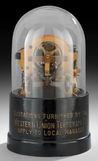 An Edison Western Union type stock ticker machine with original glass dome