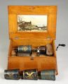 A Capital Cuff Style A music box made by F.G. Otto and Sons in a quarter sawn oak case with four cuffs and original decal