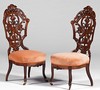 A pair of circa 1865 Mitchell & Rammelsberg Victorian Rococo Revival parlor or side chairs in rosewood having pierced and carved backs over upholstered seats on front cabriole legs with casters