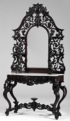 A circa 1860 Victorian Rococo Revival rosewood etagere comprising a mirror with pierce and floral carved crest and surround with shelves over a white marble top and carved long drawer on cabriole legs joined by a stretcher with three circular raised display platforms