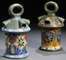 A lot of two Zuid Holland Gouda Rhodian pottery lanterns, Netherlands, circa 1915 each with looped handle, conical vents, Candia and Sana pattern