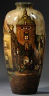 A Zuid Holland Gouda pottery high glaze City Gate ovoid vase, Netherlands, early 20th century, hand-painted scene of a city street beneath an old entrance gate