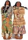 Two large Native American skookum display dolls, early 20th century both wrapped in blankets, one having a string of beads