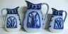 A lot of three Flow Blue graduated jugs / pitchers, Cattails pattern, relief cattail medallion on each side on bamboo molded g