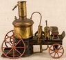 A Schoenner live steam tin and brass fire pumper with vertical boiler