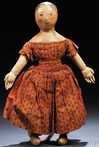 An oil painted cloth girl doll possibly by Izannah Walker wearing her original hand-stitched printed cotton dress and underclothes