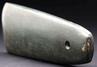 A greenstone celt with a hole drilled near one end, like a pendant