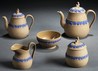 A five-piece Wedgwood Drabware tea service, England, 19th century, each with applied blue fruiting grapevine band, the covers with Sybil finials