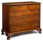 A Chippendale cherry four drawer chest on ogee bracket feet