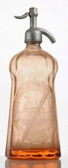 A Dr. Pepper pink seltzer bottle etched with Dr. Pepper Bottling Co., Zetz Sparkling Water, New Orleans, LA