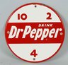 A Dr. Pepper 10-2-4 Drink Dr Pepper round porcelain sign