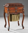 A carved rosewood Rococo Revival sewing table by Mitchell & Rammelsberg, Cincinnati, Ohio, mid-19th century, the cove molded lift lid over a single drawer and a work basket