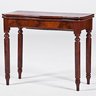 A serpentine game table on turned legs, mahogany, by Mitchell & Rammelsberg, Cincinnati, Ohio, 19th century