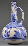 A Gouda Het Hert matte glaze vase, art pottery Holland, circa 1900, bottle form with hand-decorated design in blue on white ground, marked with stylized stag's head