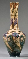 A Gouda high glaze vase, art pottery, Plateel Bakkerij factory, Zuid, Holland, early 20th century, elongated neck over tapering form with overall florwers and foliate