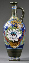 A Gouda handled vase, art pottery Holland, early 20th century, polychrome floral decoration on olive ground