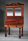 A Maryland Classical secretary or desk and bookcase attributed to John Needles, Baltimore, circa 1820 to 1830, the gallery top with scrolled pediment, on columnar legs with ball feet, mahogany and figured maple
