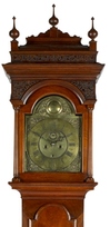 A Philadelphia Queen Anne walnut tall case clock with eight-day works and brass face inscribed Peter Stretch