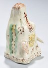 A Staffordshire pottery or creamware stirrup cup, England, 18th century, modeled in the form of a cow's head and decorated in translucent underglaze enamels