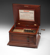 A Regina coin-operated music box, American, late 19th to early 20th century, double comb Regina music box for 15.5 inch discs, includes crank and original instruction sheet in lid, serial no. 59157