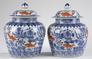 A pair of Ming style underglaze blue and iron red enamelled jars and covers, decorated with goldfish among water weeds